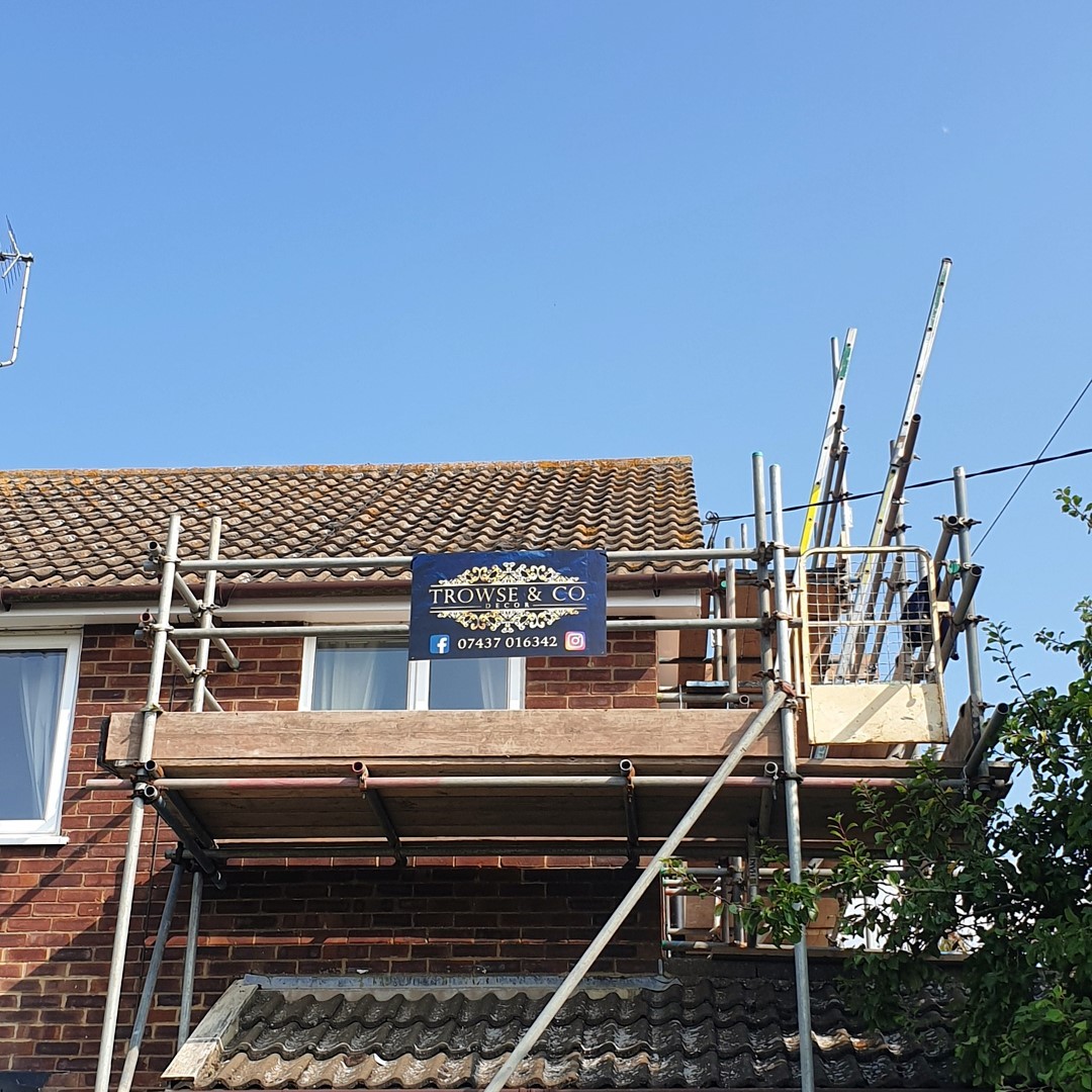 Trowse & Co Decor site board on scaffolding at a house